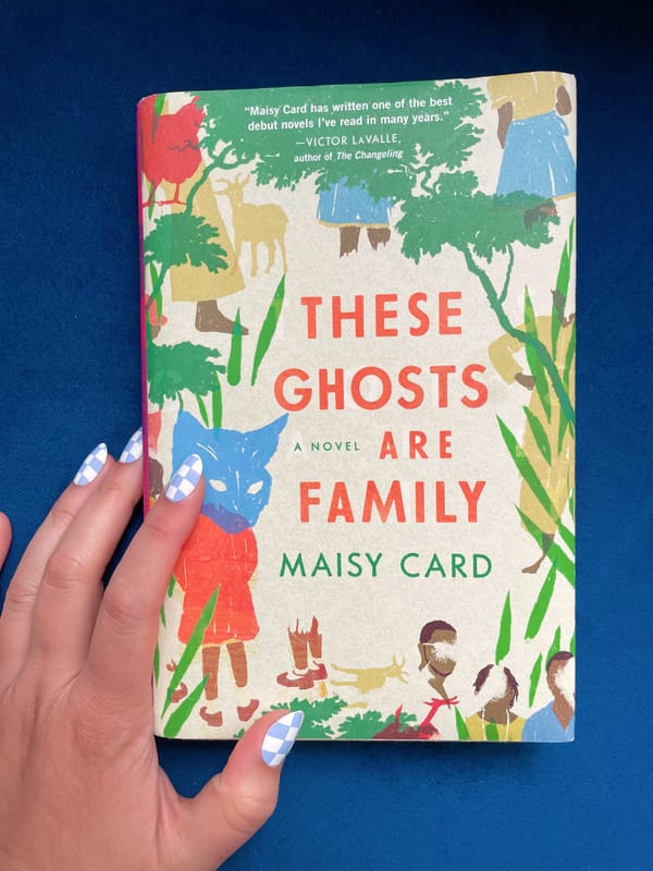 Maisy Card's These Ghosts Are Family book on a blue background