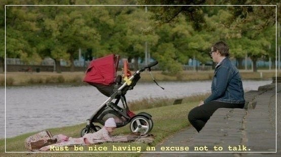 Person sitting at the edge of a river with a baby. Caption reads, "Must be nice having an excuse not to talk."